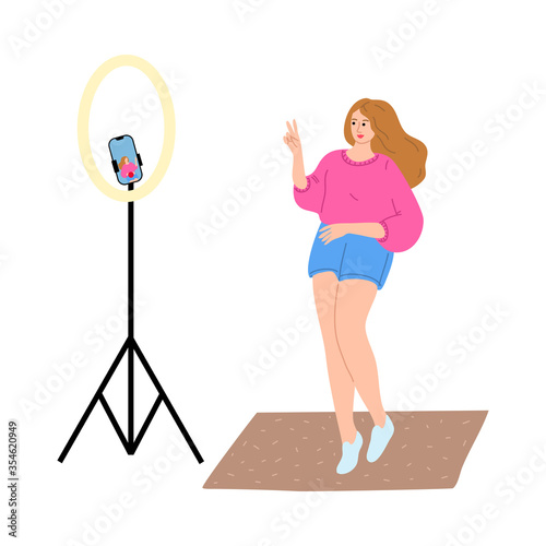Woman blogger standing and making photo for blog on phone camera