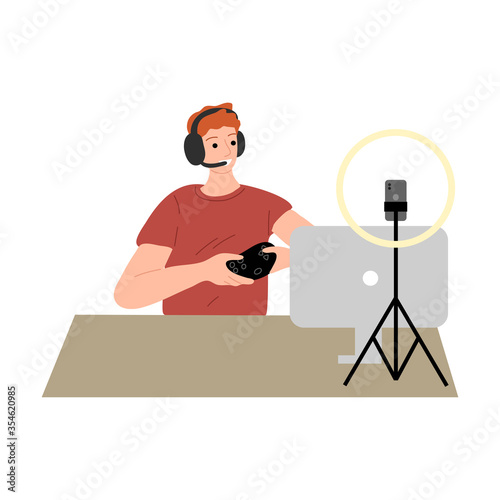 Blogger in headphones sitting and making video for blog on phone camera
