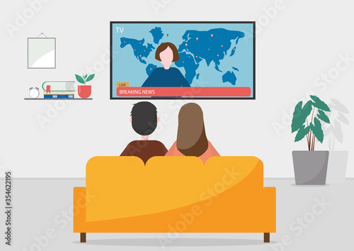 Family sitting on sofa at home and watching the breaking news
