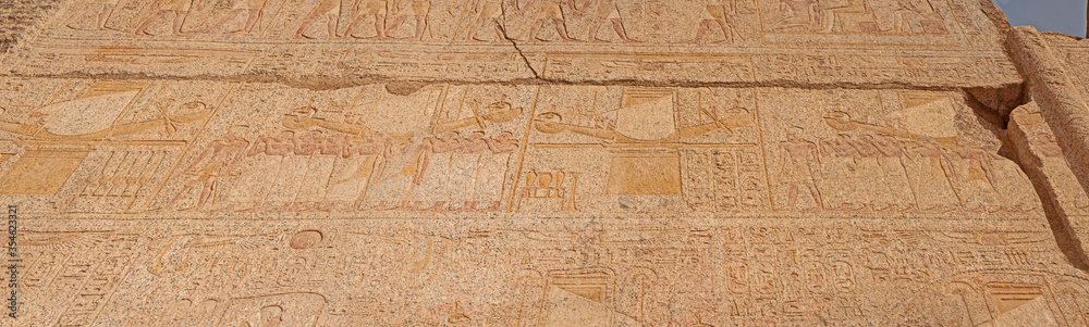 Hieroglyphic carvings on an ancient egyptian temple wall