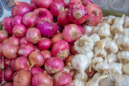 an image of raw white garlic and red onions togather