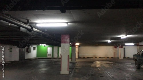 Flashing light in the underground car park. Broken fluorescent lamp in the basement of parking lot. Horrible surrounding. 
