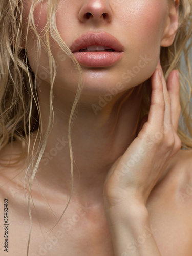 Glamour portrait of beautiful woman model with fresh daily makeup. Fashion shiny highlighter on skin, sexy gloss lips make-up and perfect eyebrows. Natural beauty