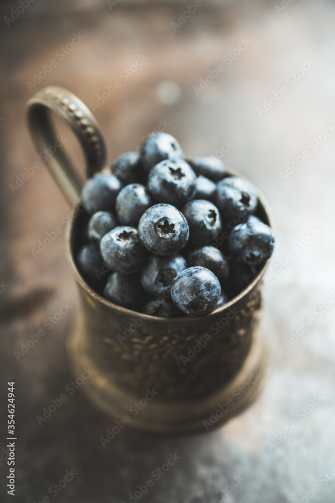 Freshly harvested blueberries in metal cup. Selective focus. Shallow depth of field.
Freshly harvested blueberries in metal cup. Selective focus. Shallow depth of field.