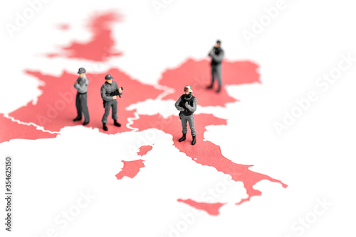 Miniature police on top of map of europe