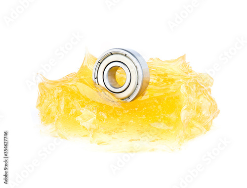 Ball bearing with yellow grease on white background photo