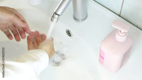 Disinfection of hands with soap in the dressing room. Hand washing rubbed with soap to prevent coronirus. Hygiene to stop the spread of coronavirus.
 photo