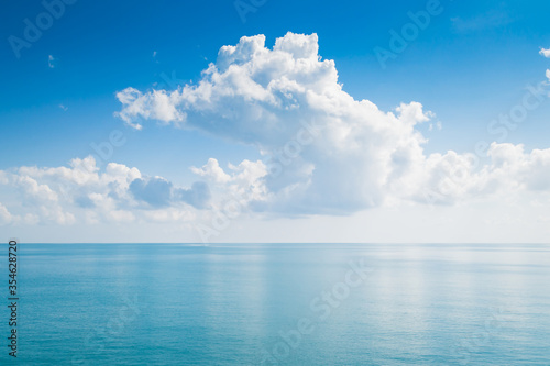 White fluffy clouds and turquoise sea on blue sky