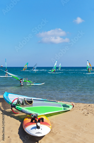 Fototapeta Naklejka Na Ścianę i Meble -  Active summer vacation. People windsurf on the Mediterranean coast on a hot sunny day. Greece, Rhodes, Prasonisi (people out of focus)