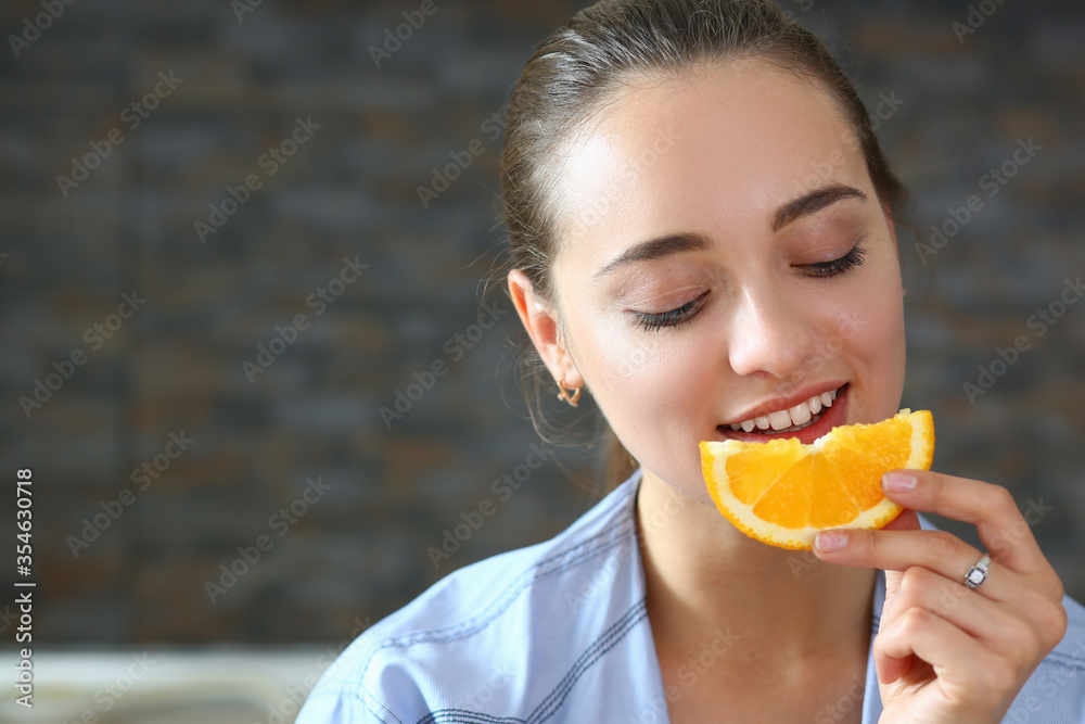 Close up of pleased woman that eating citrus Close up of pleased woman that eating citrus