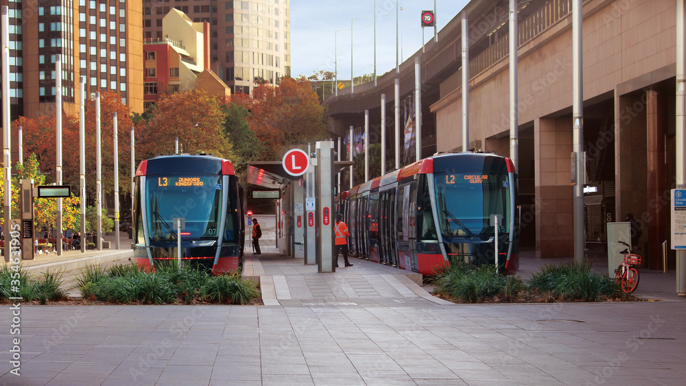 Streetscape outside Circular quay light rail station. Pictured are two light rail trains. - obrazy, fototapety, plakaty 