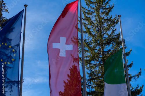 Swiss flas betwenn european and italien flag photo