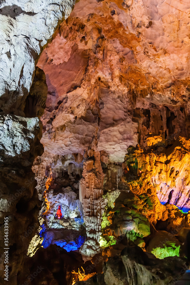 Naklejka premium Stalactite and stalagmite formations in a limestone cave of Halong Bay, Vietnam