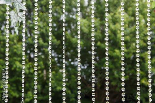 Fragment of a curtain of plastic or glass beads on the wedding ceremony