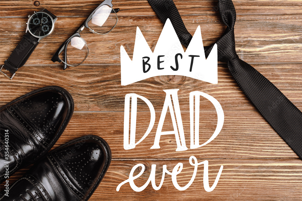 Φωτογραφία Top view of mens black shoes, tie, wristwatch and glasses on wooden background,