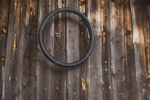 old bicycle tire on a wooden wall