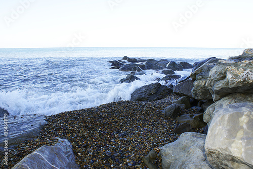 Waves breaking on stones, seashore