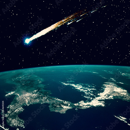 Fototapeta Naklejka Na Ścianę i Meble -  Comet flying above the earth. The elements of this image furnished by NASA.
