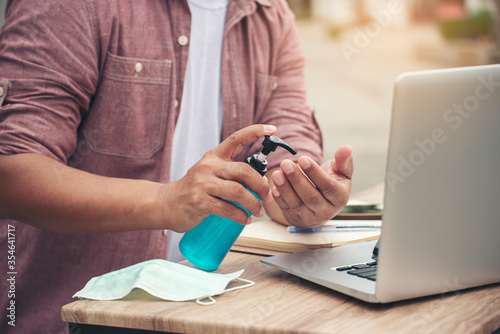 Asian man washes and clean hands with alcohol gel To protect from 2019-ncov virus and bacteria at home.Covid-19 Virus Protection concept.