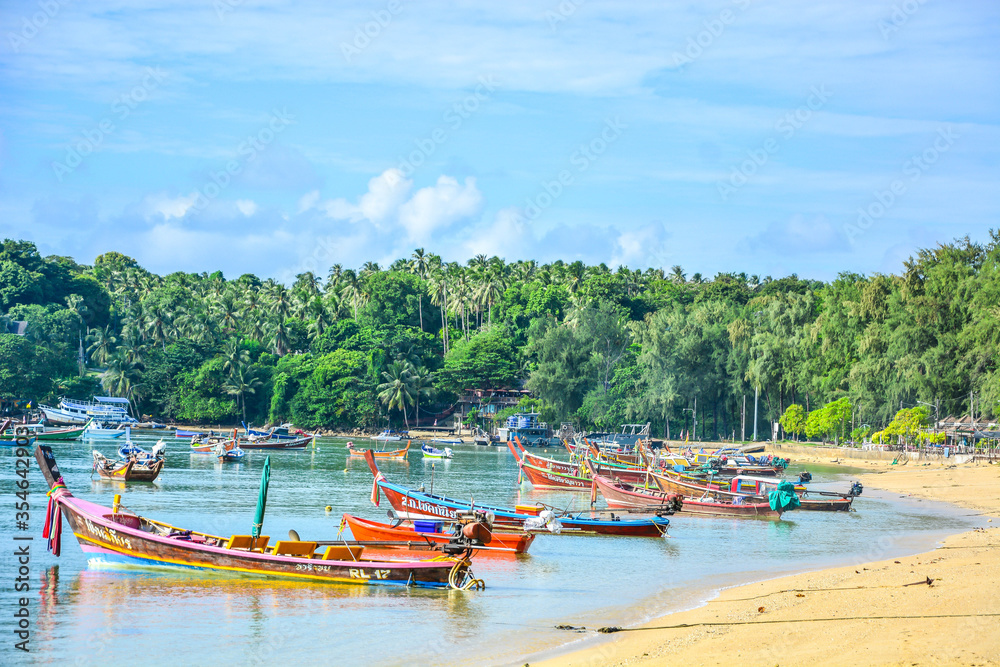 Peaceful background of nature landscape and local lifestyle of Thai fisherman village and wooden boats floating with sea view in Phuket, Thailand. Thailand tourism background