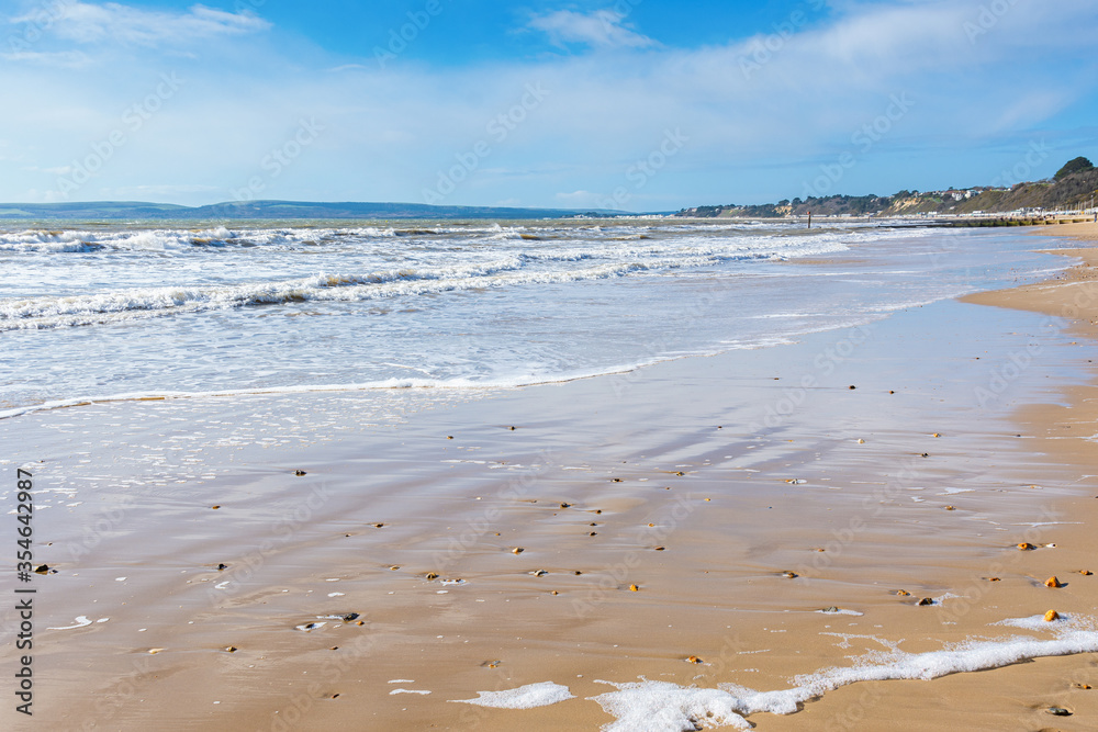 Fototapeta premium Sandy Bournemouth beach in spring, view of the blue sea, selective focus