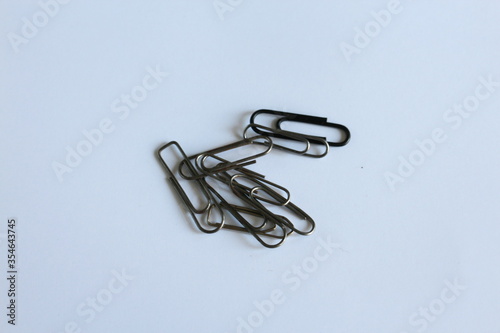 several metal clips on a white table