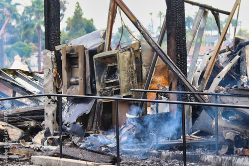 smoldering bank and atm machine after fire from protests and looting