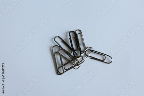 several metal clips on a white table