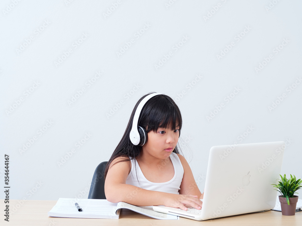 Little girl doing online class. Little girl doing online class.