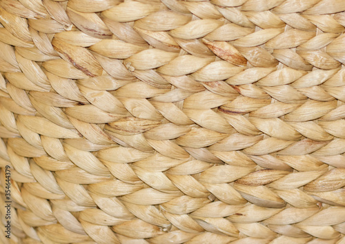 Natural textured background of light coloured woven grass type material