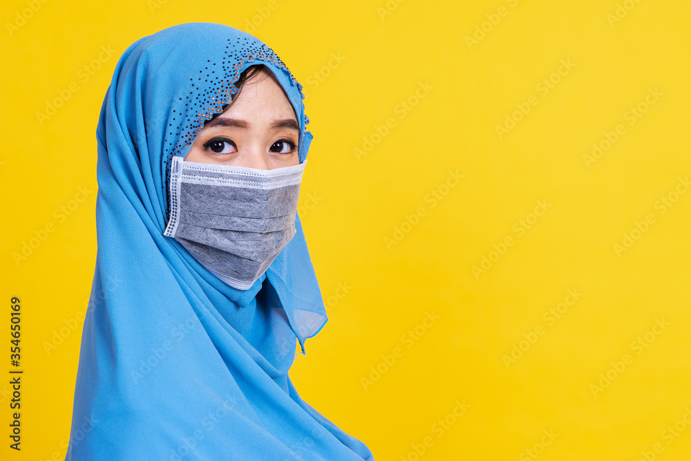Side view of Asian woman in medical mask Coronavirus pandemic disease isolate background. COVID-19 virus epidemic outbreak. Side view of Asian woman in medical mask Coronavirus pandemic disease isolate background. COVID-19 virus epidemic outbreak.