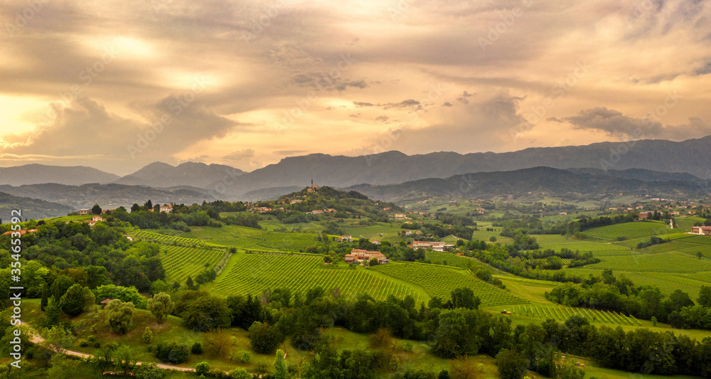 Rural landscape at sunset.  Italy mountains, hills and vineyards. panorama. Amazing sky