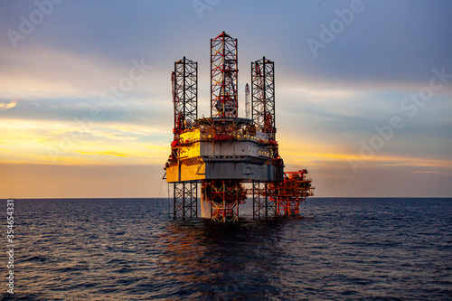 oil drilling rig at sunset