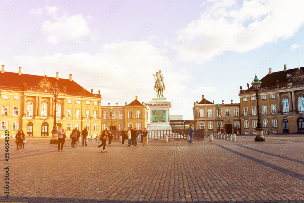 Beautiful old buildings of Amalienborg castle with the equestrian statue in Copenhagen city center at summer day, Denmark. Amalienborg castle in Copenhagen, Danmark. Old Copenhagen city center