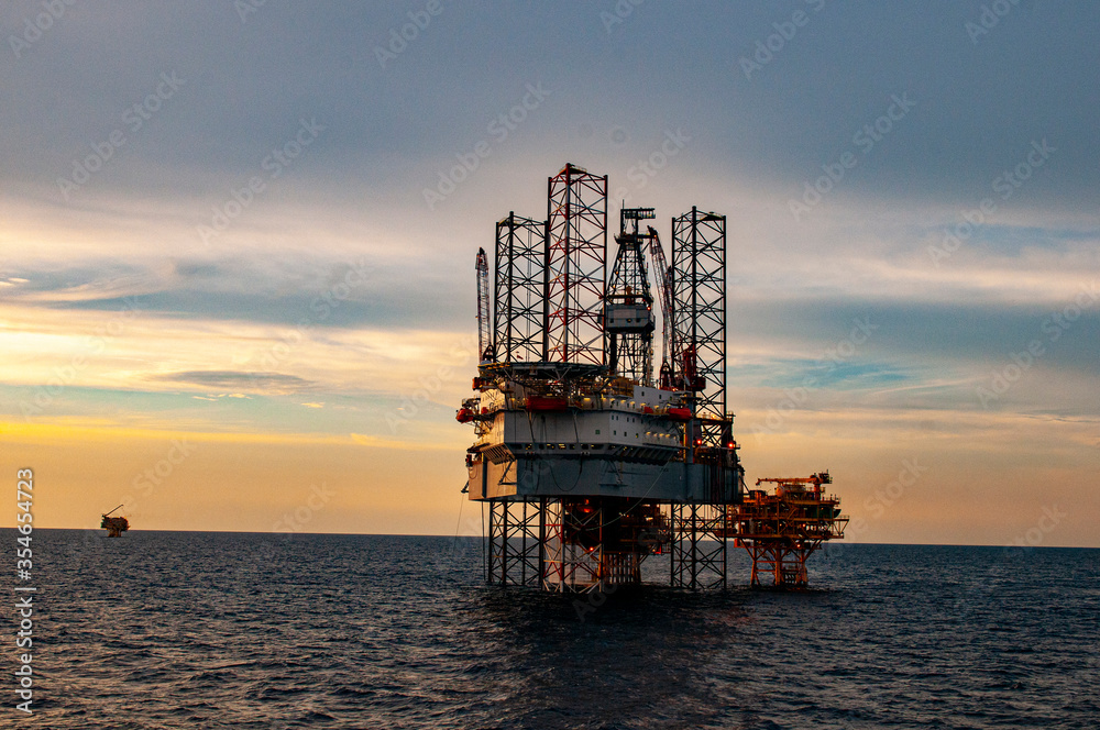 oil drilling rig at sunset