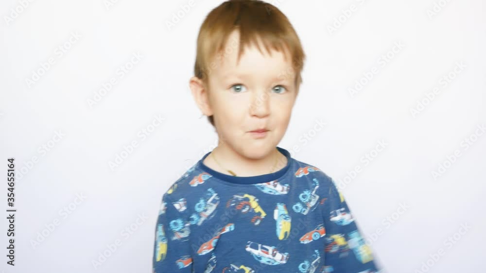 An attractive little boy fools around looking at the camera An attractive little boy fools around looking at the camera