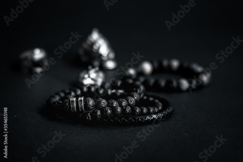 men lava stone bracelets on black background