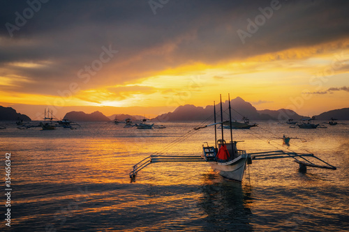 Traditional philippine boats in El Nido at sunset lights, Philippines