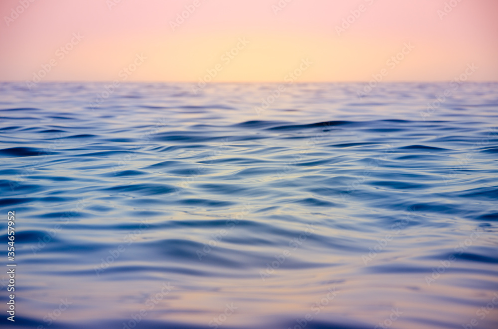 Obraz premium Seascape background colorful sea waves at sunset
