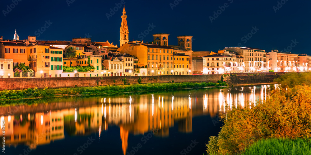 Night summer view of Basilica of Santa Croce church and Arno river. Panoramic evening cityscape of Florence, Tuscany, Italy. Traveling concept background.
