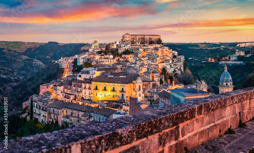 Captivating summer cityscape of Ragusa town with Palazzo Cosentini and Duomo di San Giorgio church on background. Colorful sunset in Sicily, Italy, Europe. Traveling concept background.