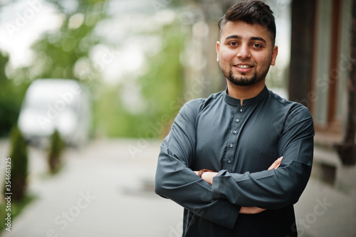 Сonfident pakistani indian muslim arabic boy in grey kameez shalwar suit. photo