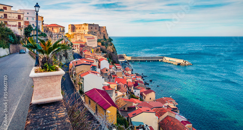 Picturesque morning view of Scilla town with Ruffo castle on background, administratively part of the Metropolitan City of Reggio Calabria, Italy, Europe. Bright summer seascape of Mediterranean sea. photo