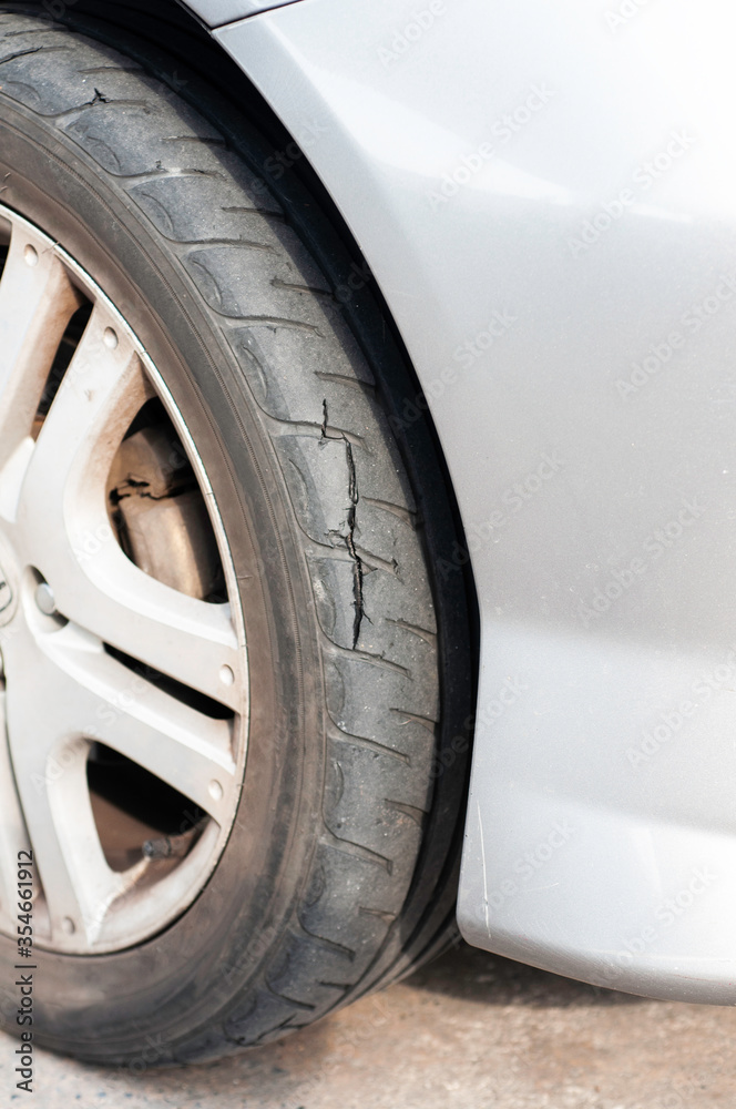 Tear marks on bald tires, car use unsafe tyre dangerous for vehicle.