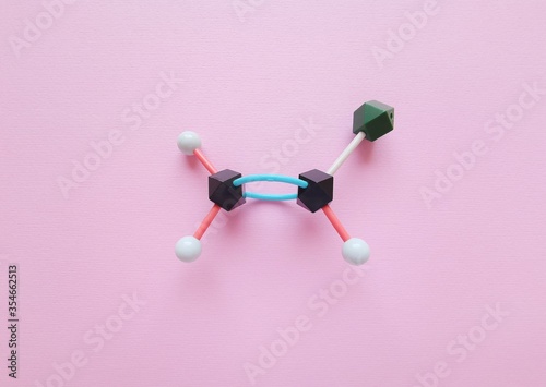 Molecular structure model of vinyl chloride. Vinyl chloride is used to produce the polymer polyvinyl chloride. It is a gas with a sweet odor, highly toxic and flammable. Black=C, green=Cl, white=H. photo