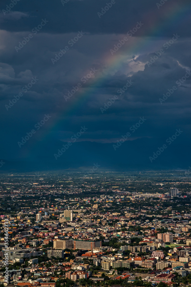 CHIANG MAI, THAILAND - May 27,2020: Aerial Panorama View of Chiang Mai City with rain cloud and rainbow, Thailand