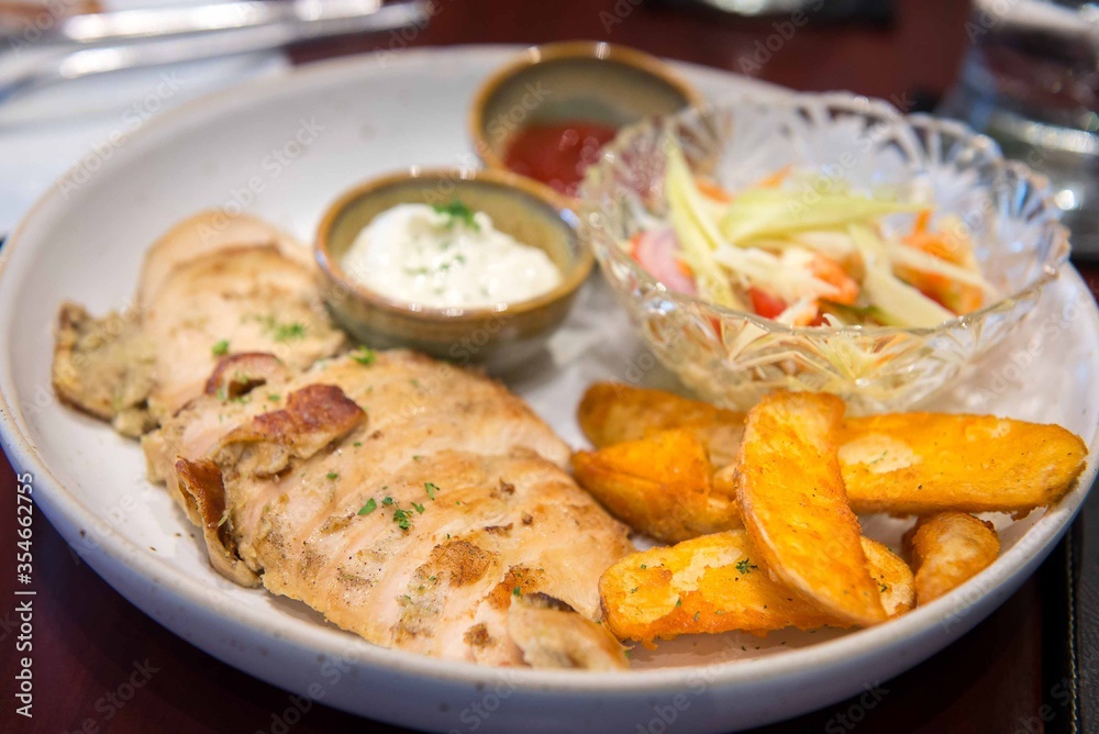 grilled chicken breast  with spicy salad and mayonnaise dip and fried potato