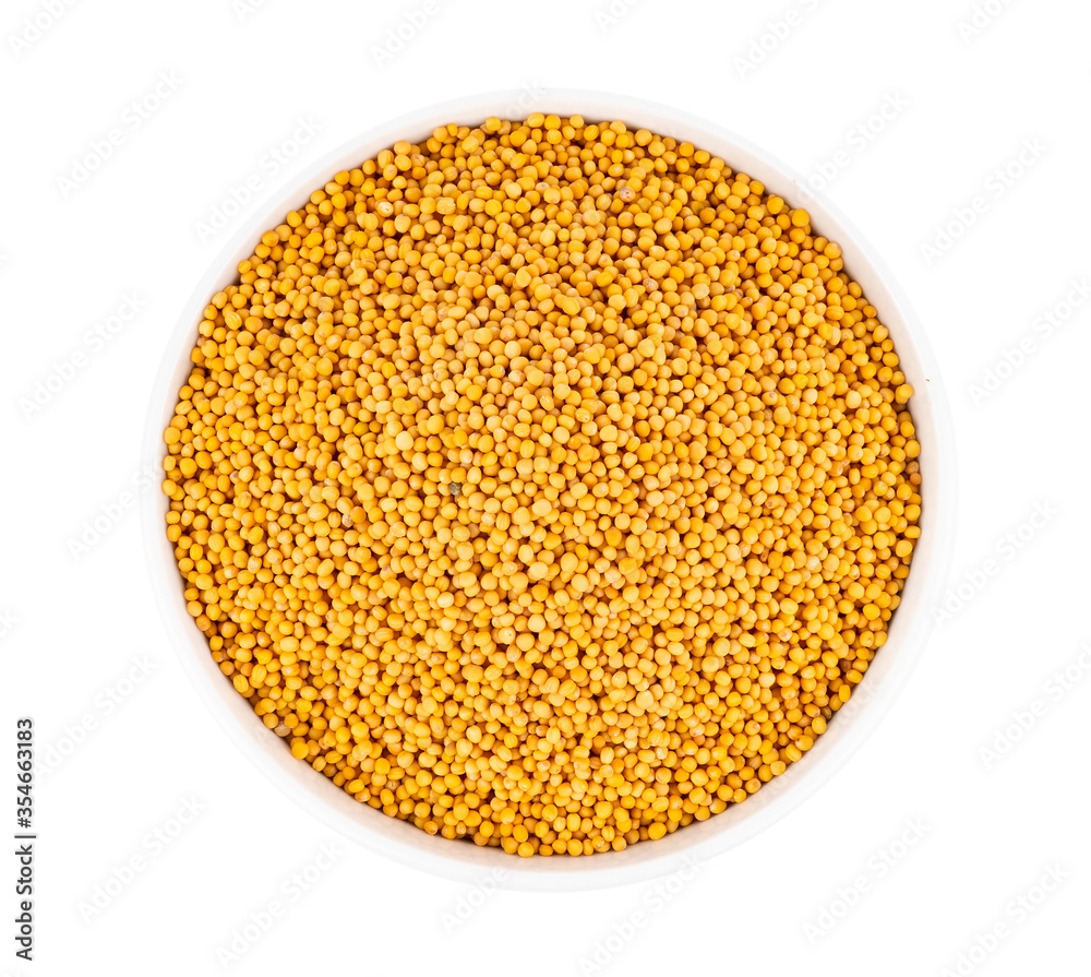 mustard seeds in bowl isolated on white background mustard seeds in bowl isolated on white background