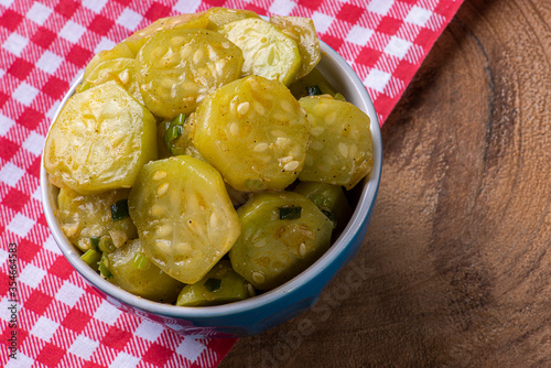 .Cooked gherkin dish. On a wooden table. Typical Brazilian dish photo