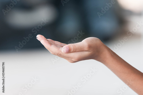 female hand showing something on the palm © Tongsai Tongjan